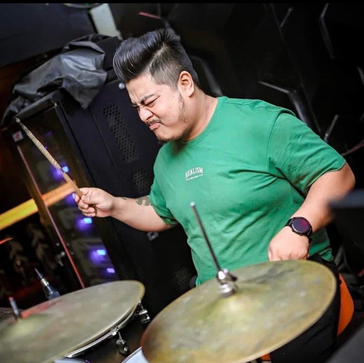 Gautam performing on drums