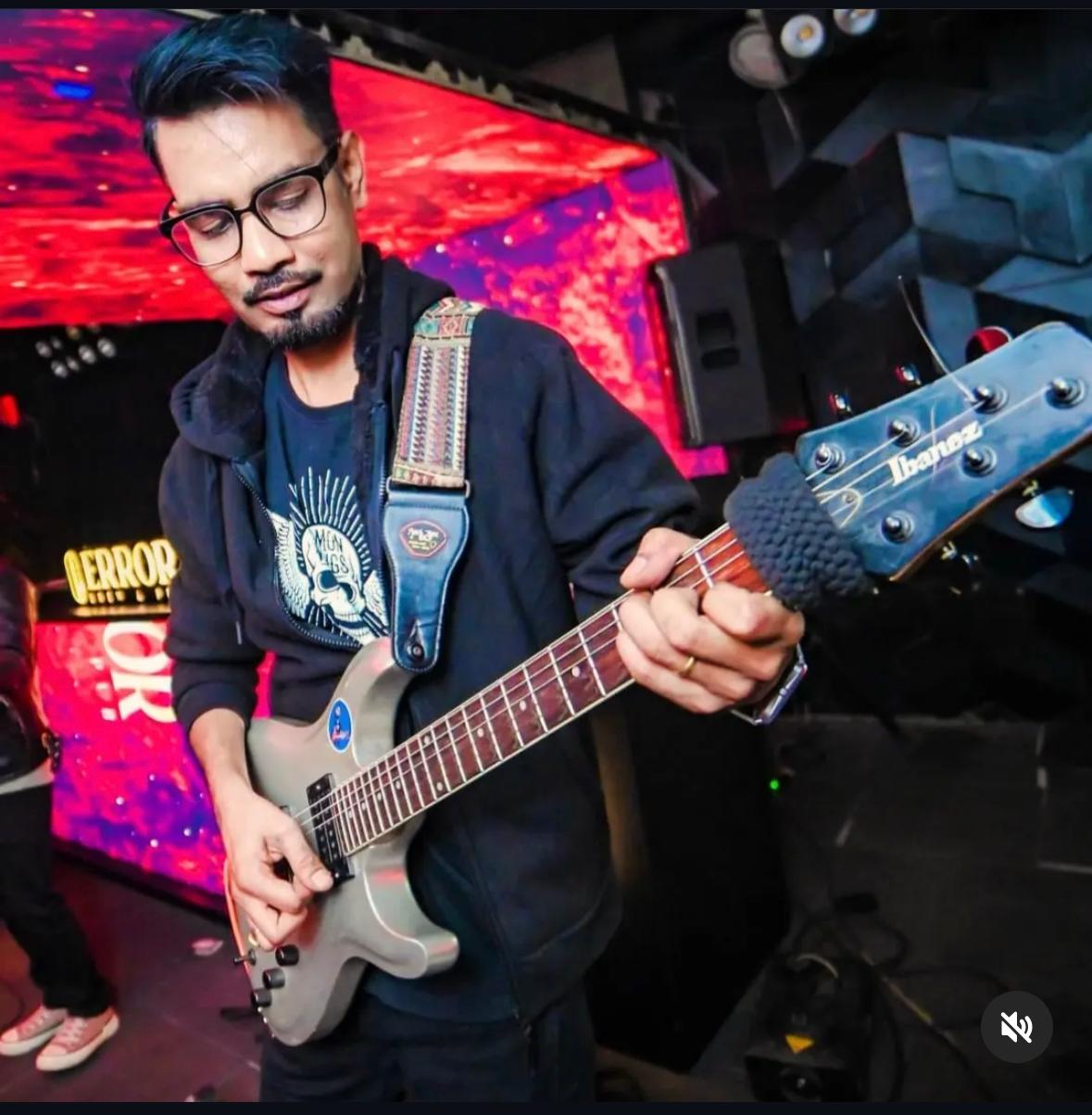 Pritam performing on electric guitar