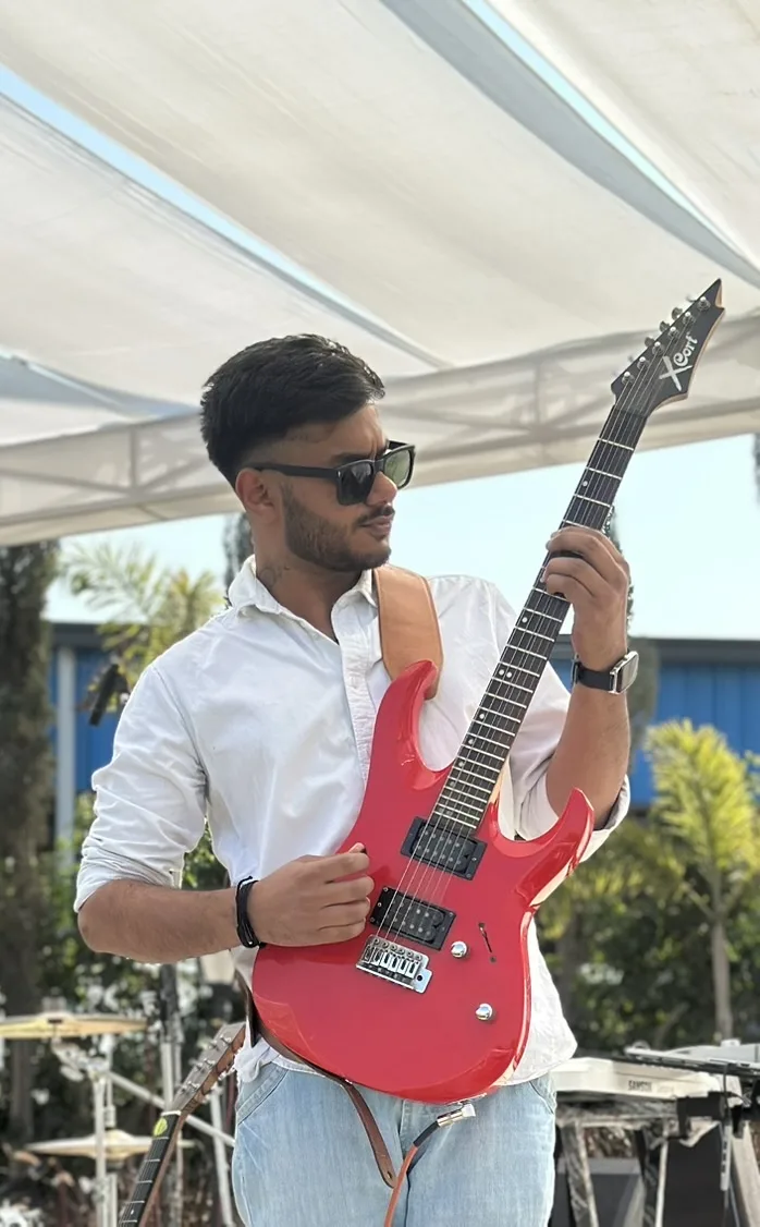 Arya Sen performing on electric guitar outdoors